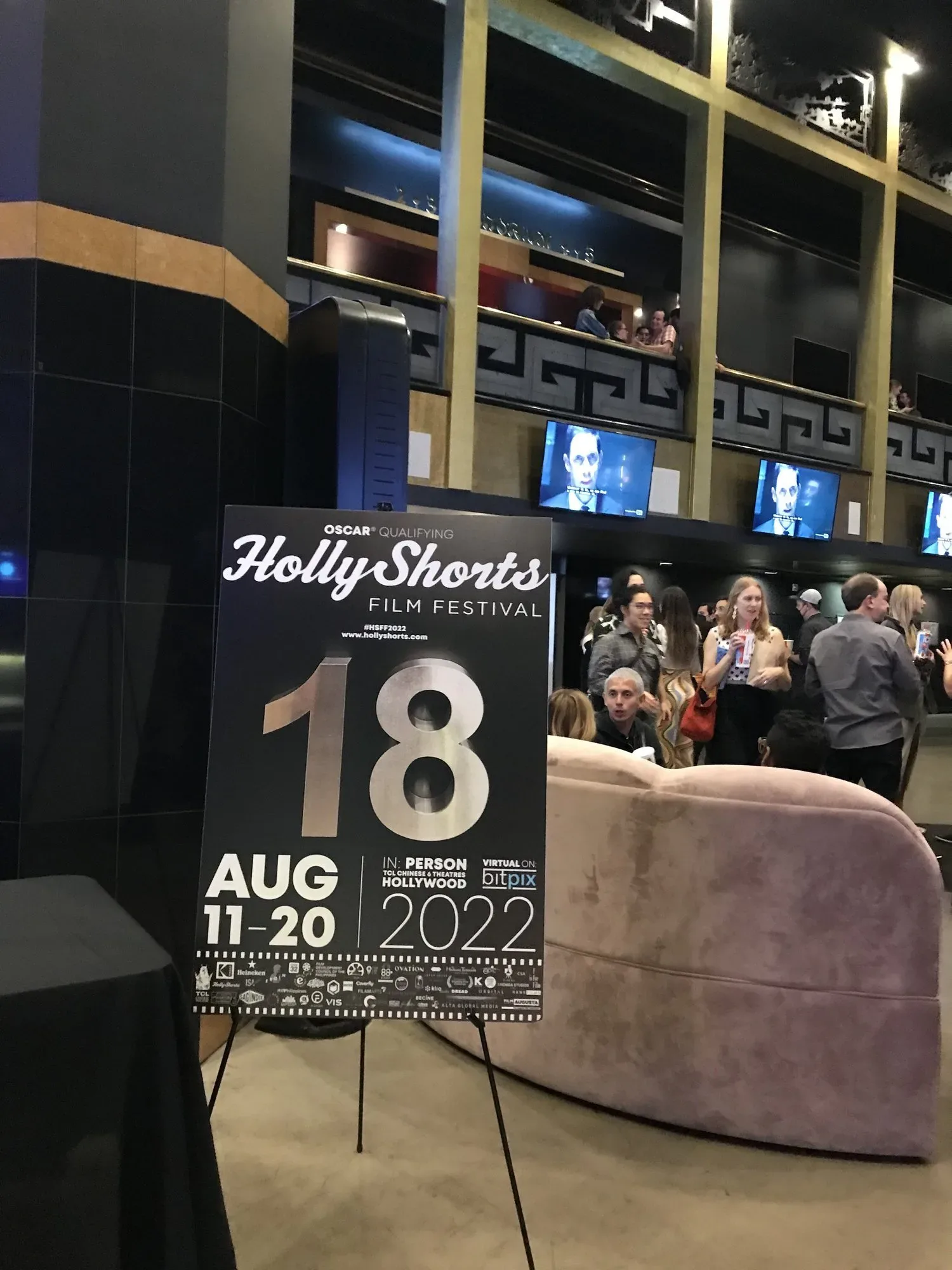 The 18 sign on an easel in the theater lobby.