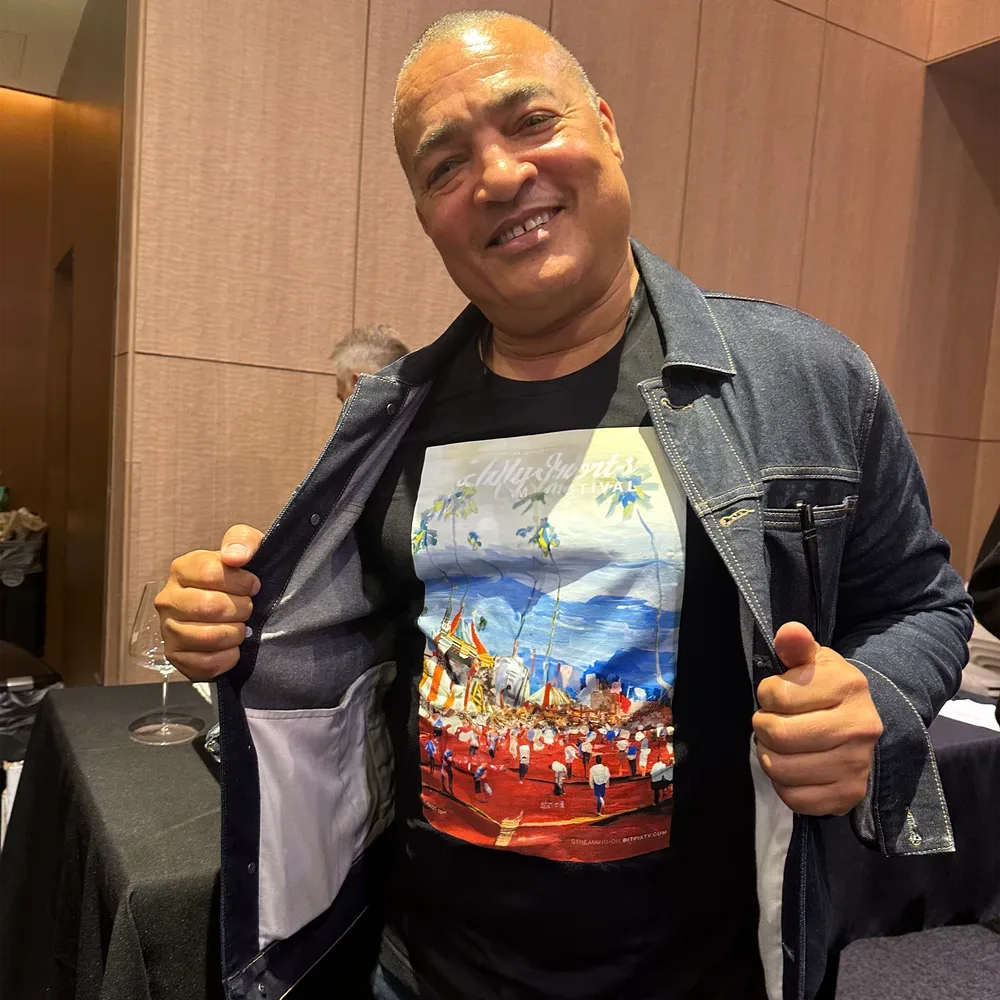 A guest wearing the festival tee printed with the poster art.