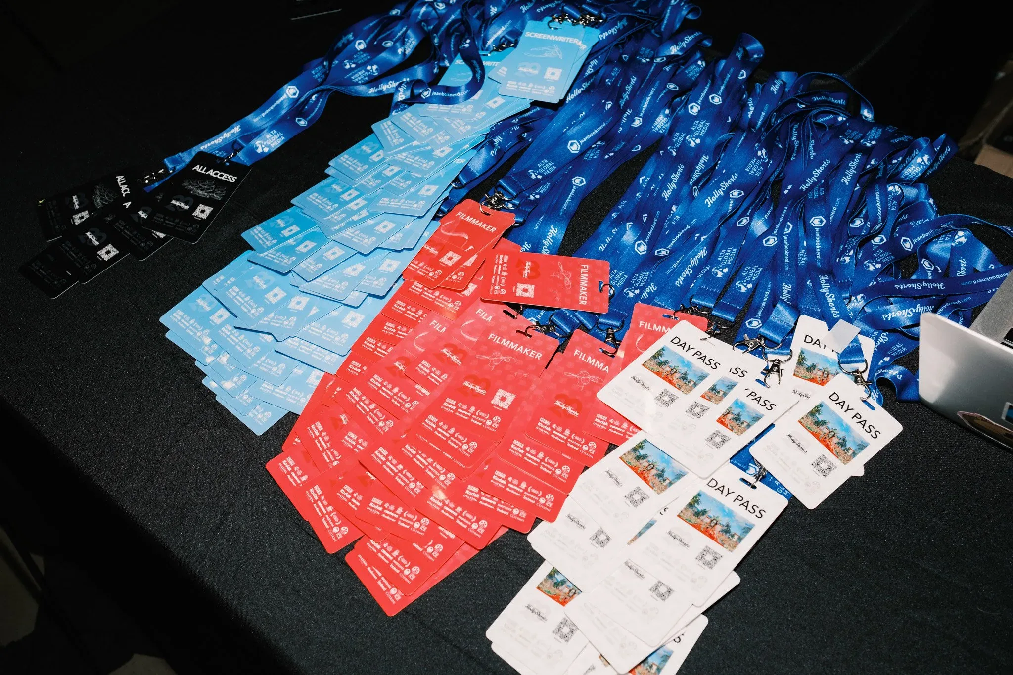 The badges and their lanyards on a table.