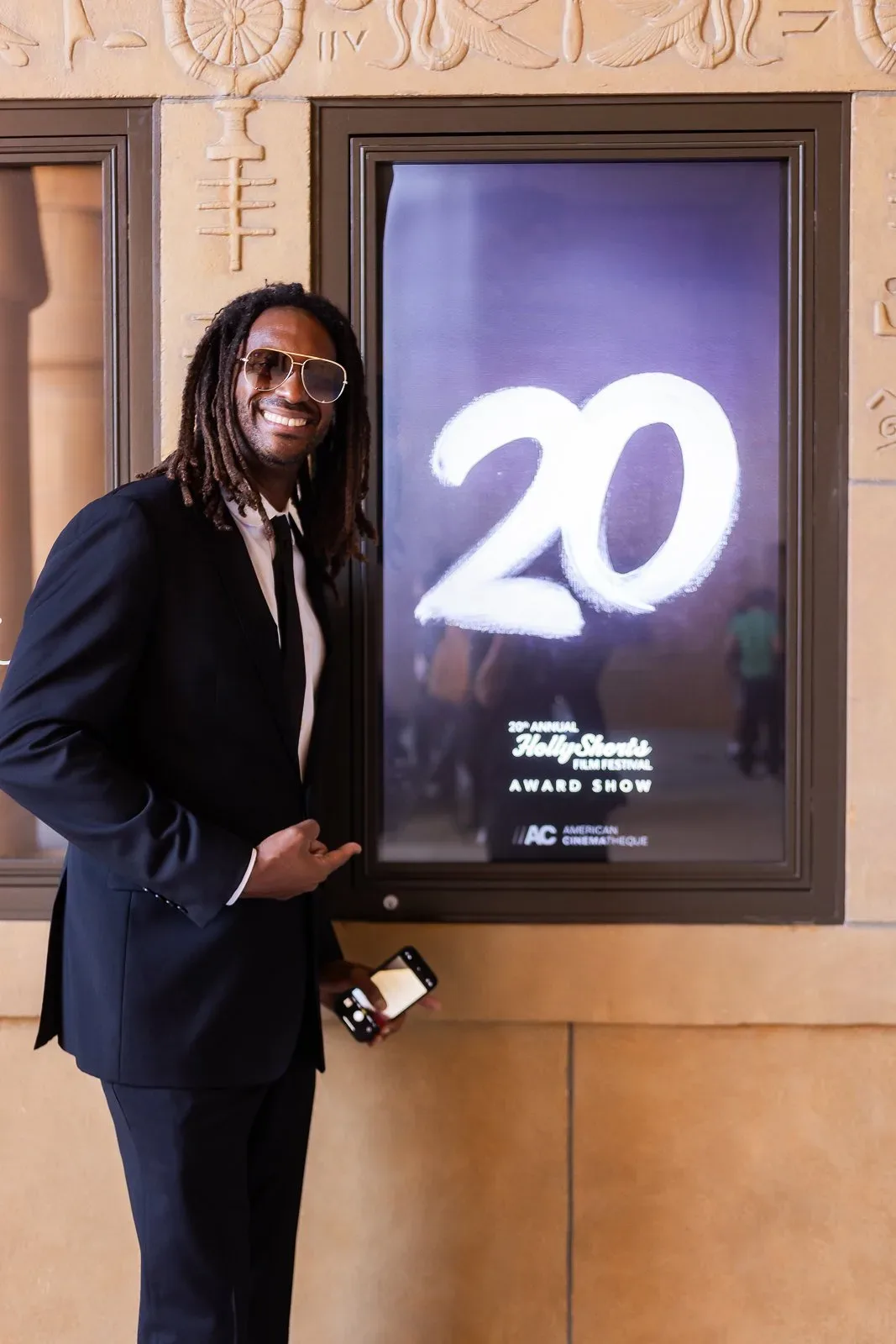 A guest beside the illuminated 20 display.