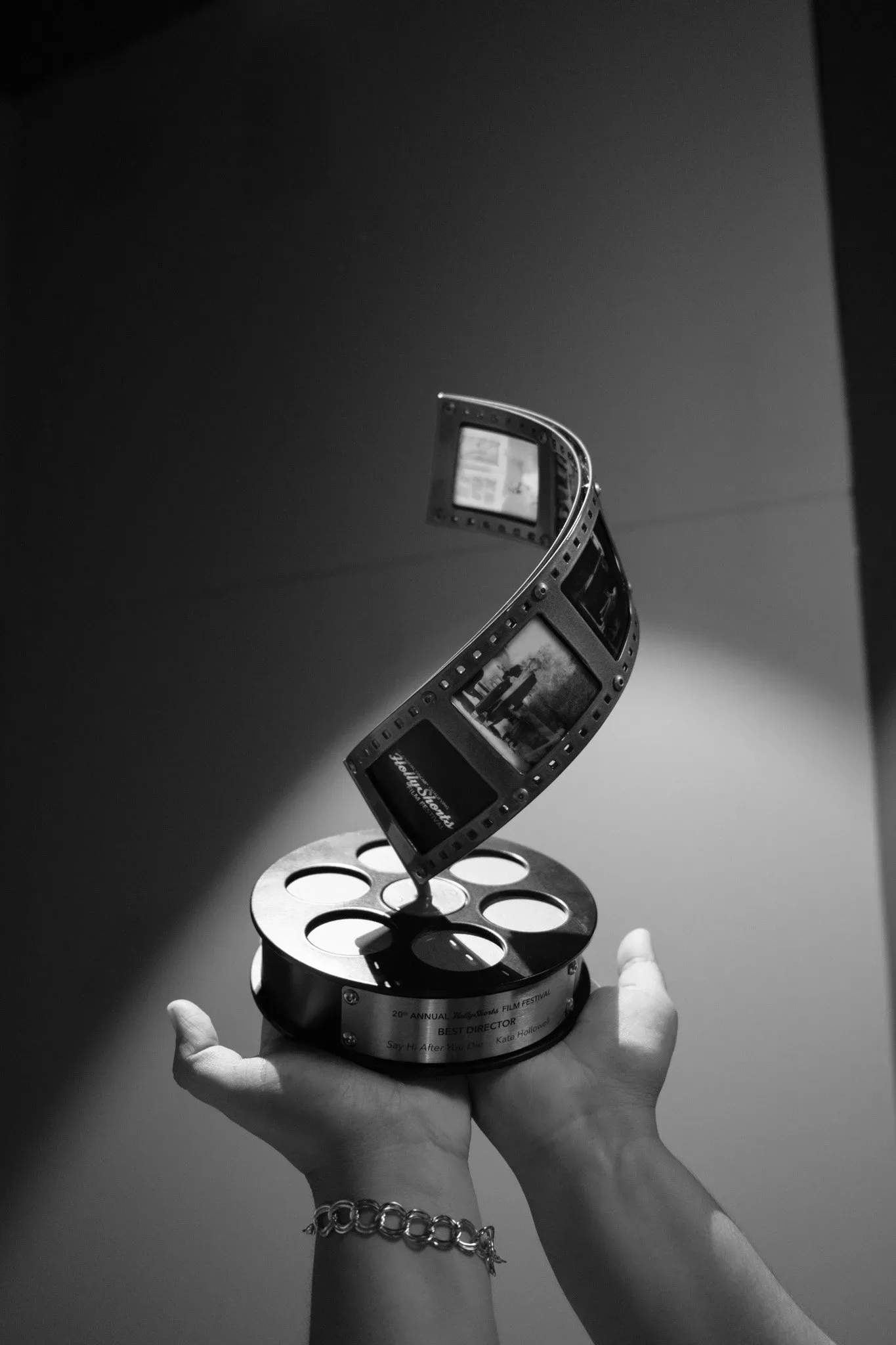 Hand holding the film-reel award