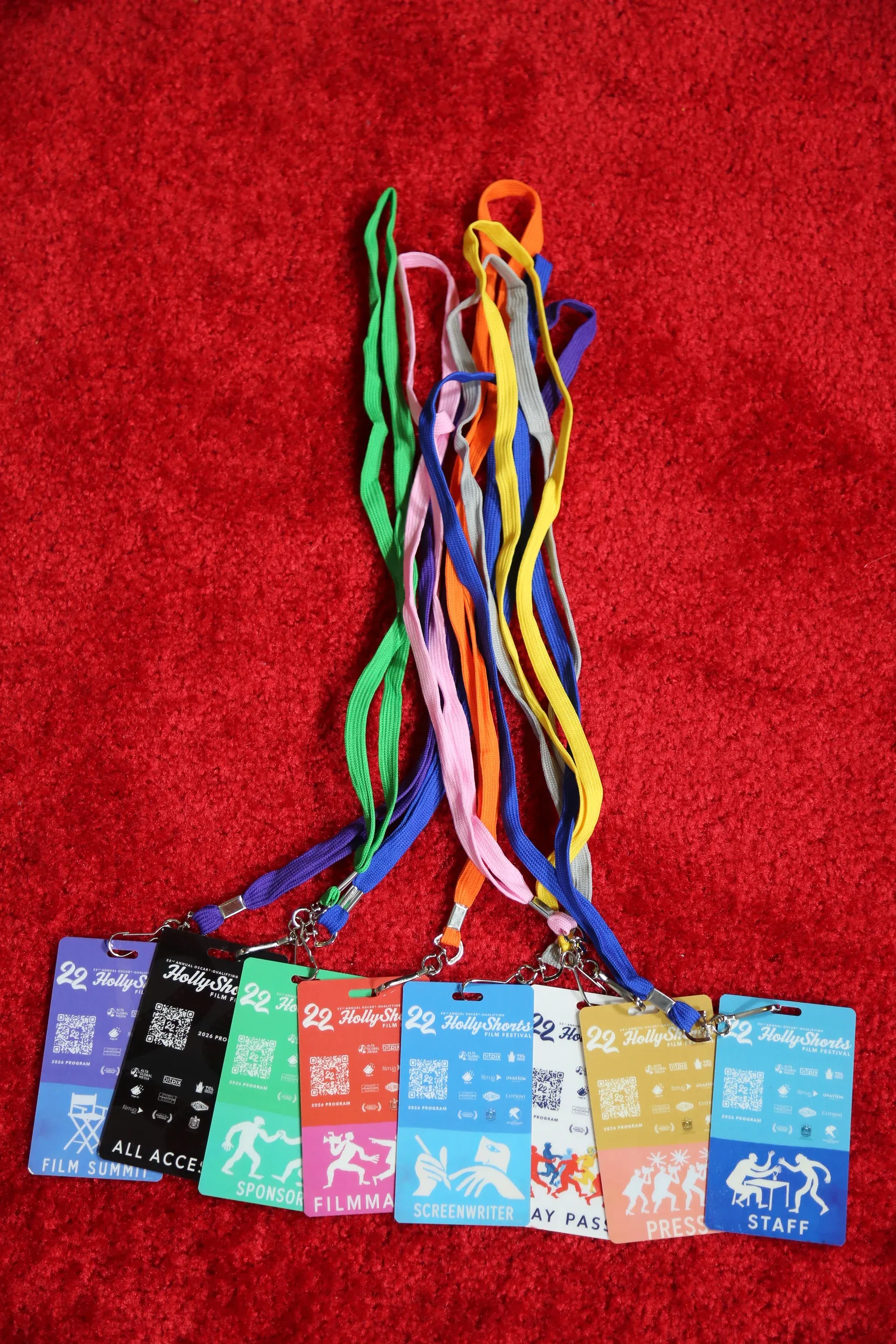 The eight badges on their lanyards, laid on the red carpet.