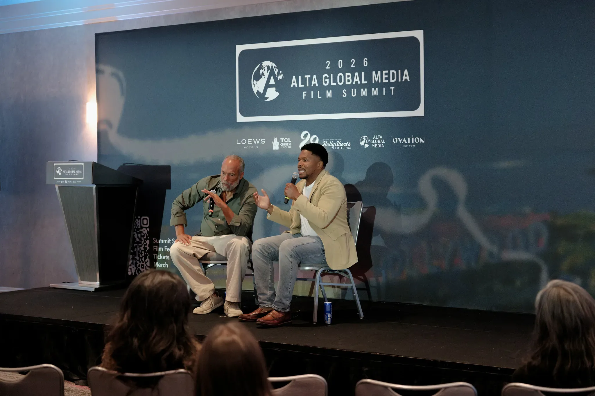 Two speakers in conversation on the summit stage