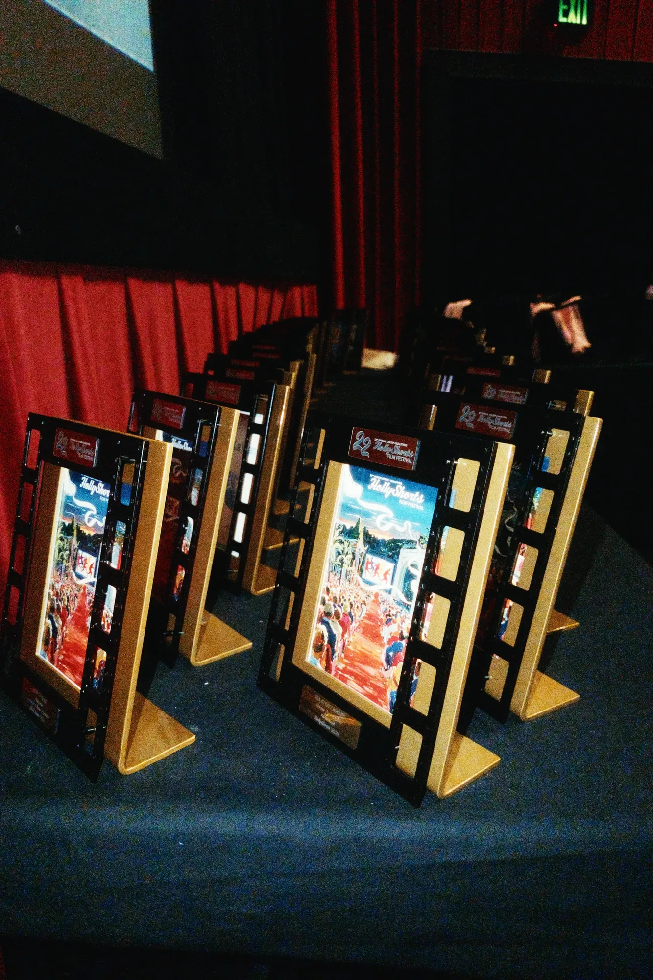 Framed award trophies lined up on stage before the ceremony