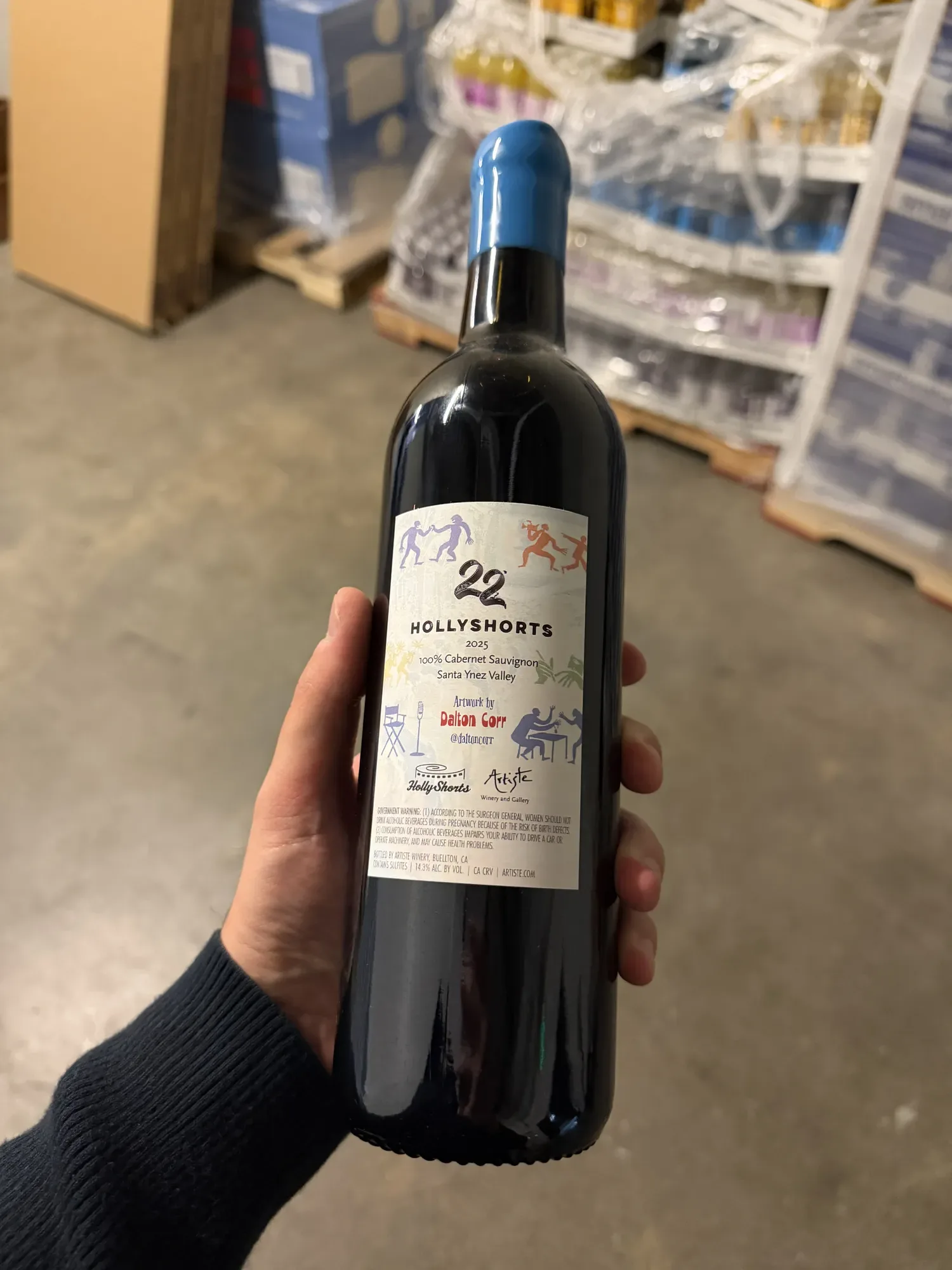 The red wine held in the hand, back label
