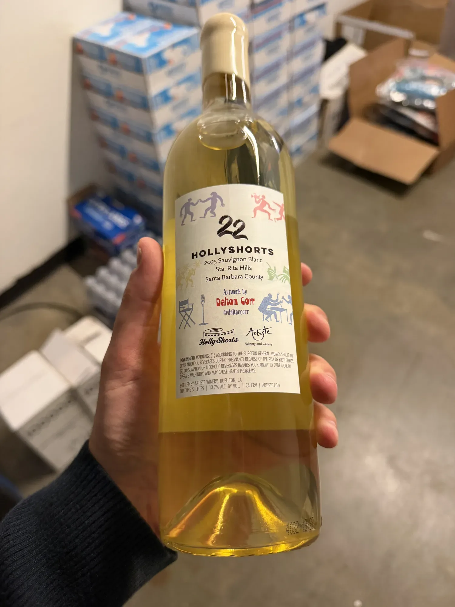 The white wine held in the hand, back label