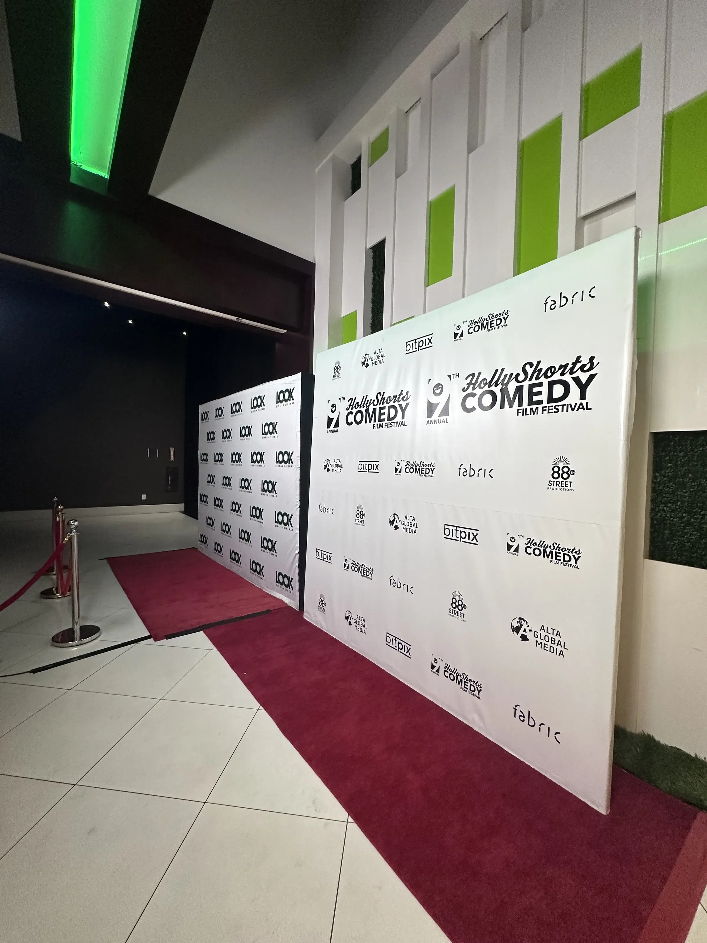 The step-and-repeat in the lobby.