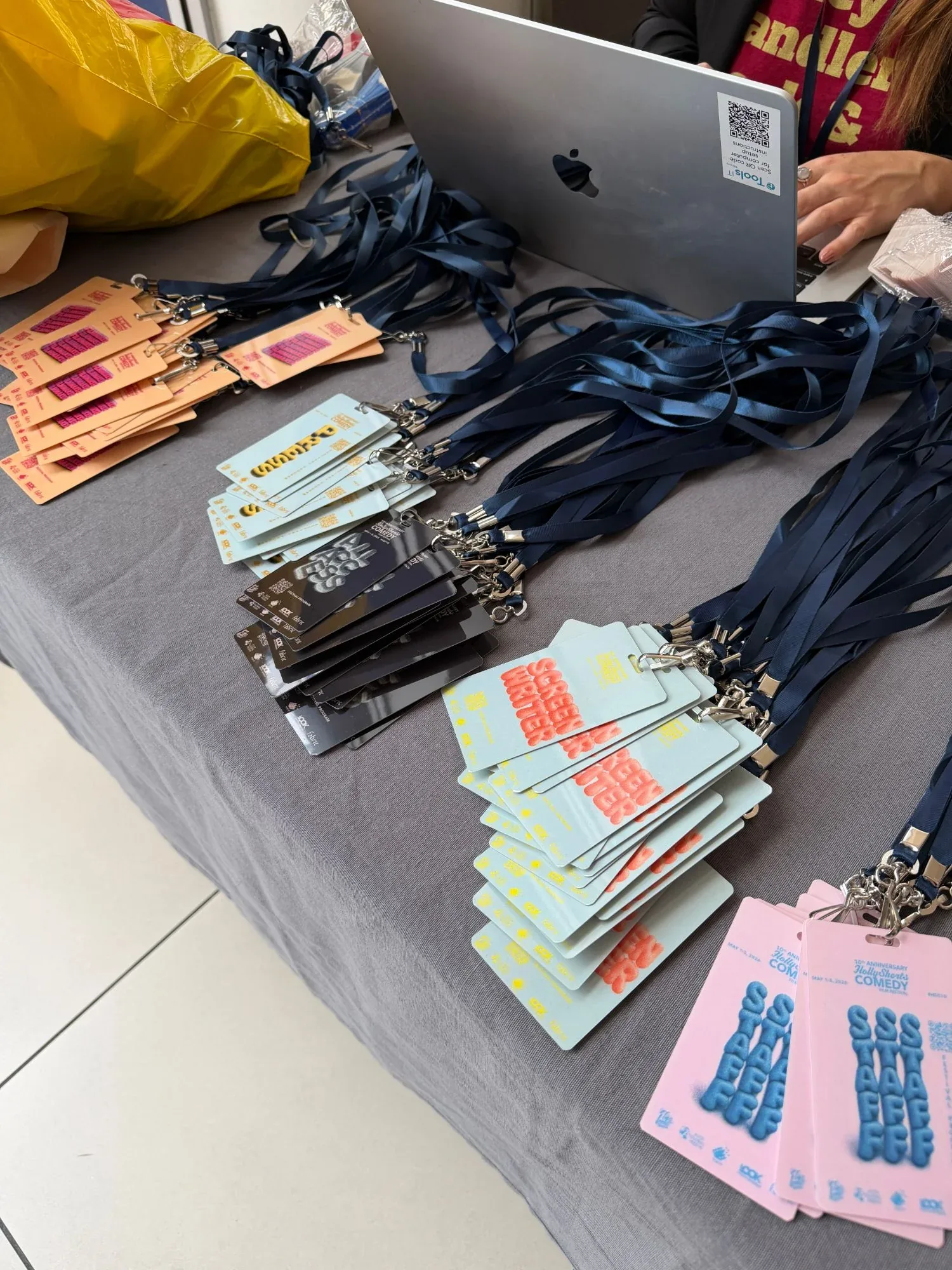 The festival badges and lanyards laid out at the check-in table