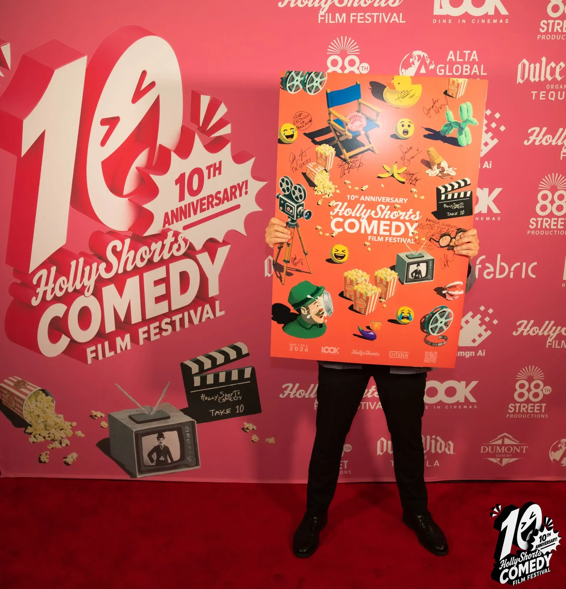 The anniversary poster, signed by the filmmakers, held up at the step-and-repeat.