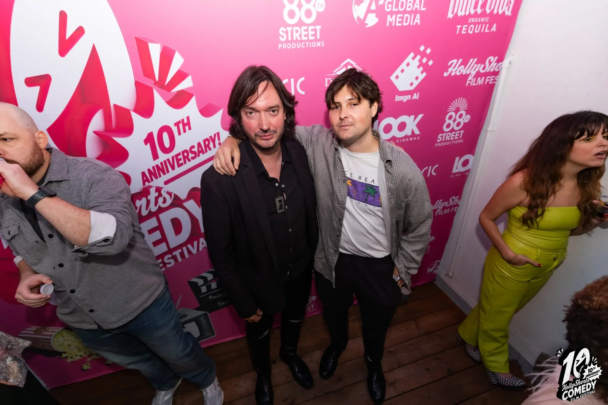 Two guests at the 10th anniversary step-and-repeat