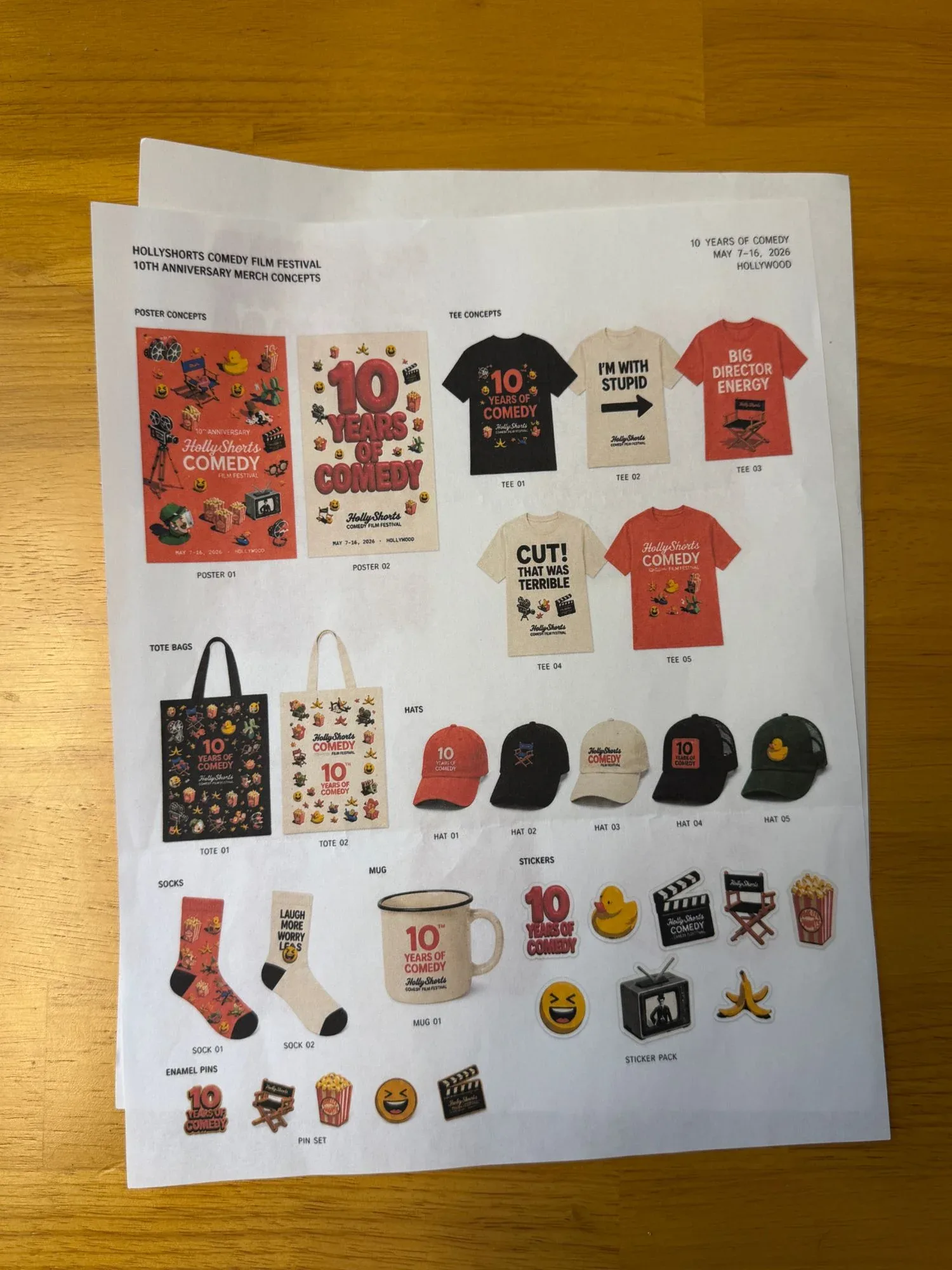 A printed sheet of merch concepts on the desk.
