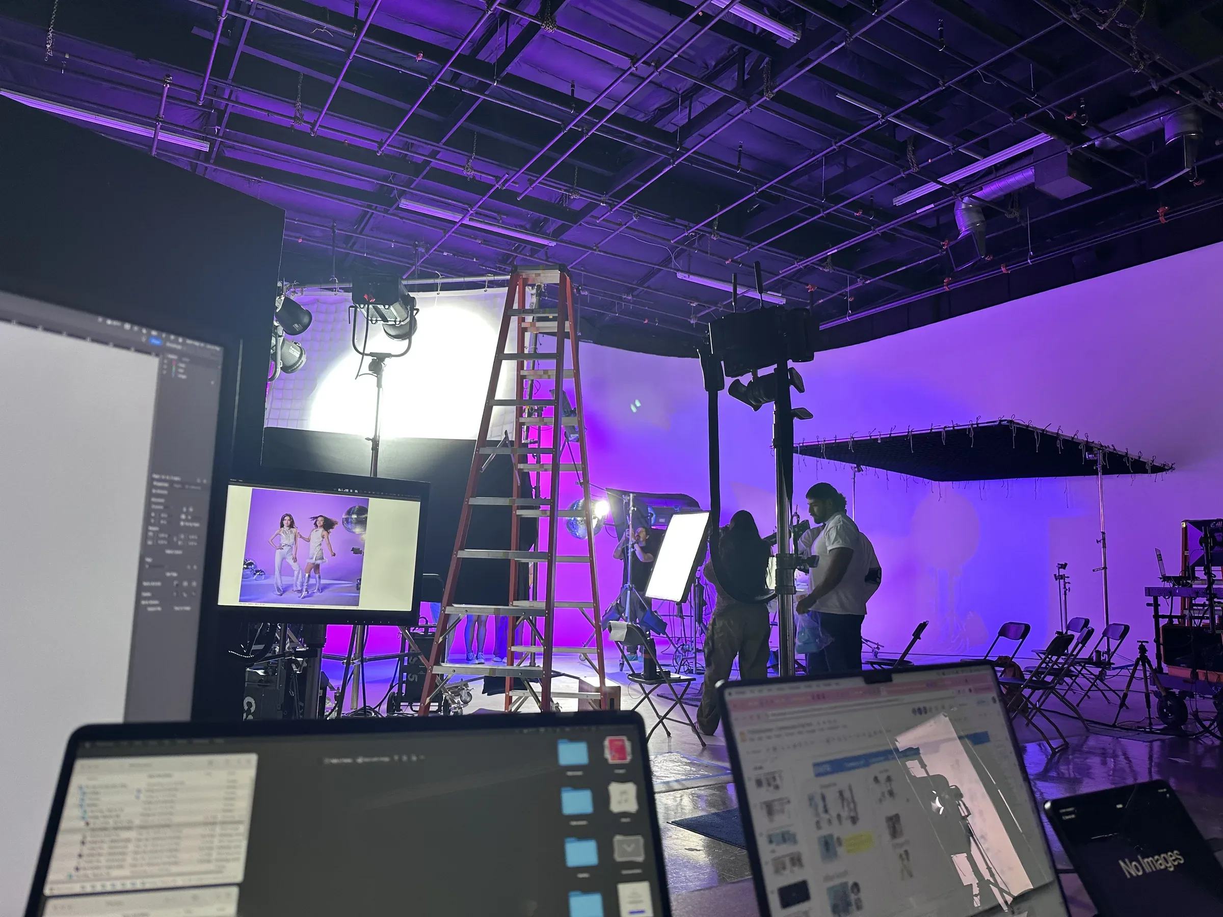 Purple and magenta set from workstation: Pop Culture section being shot with monitors and control station visible